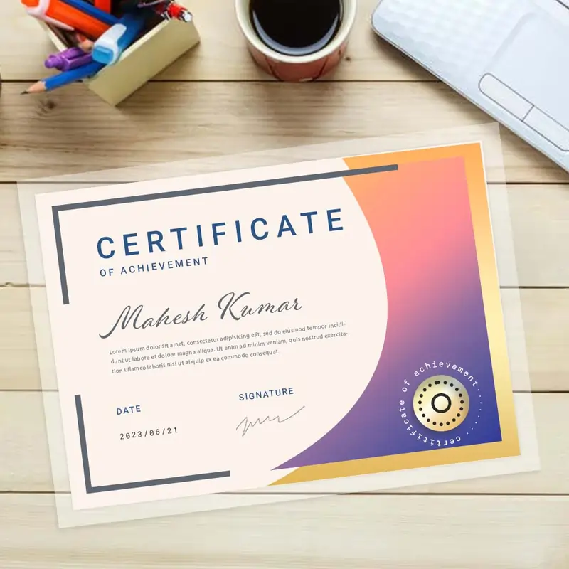 certificate-4-1 Laminated certificate for Mahesh Kumar with a purple-orange gradient on a wooden desk with coffee.