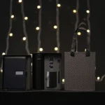 5-in-1 corporate gift set in a black box with a white notebook, thermos, accessories, and a matching gift bag.