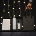 5-in-1 corporate gift set in a black box with a white notebook, thermos, accessories, and a matching gift bag.
