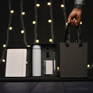 5-in-1 corporate gift set in a black box with a white notebook, thermos, accessories, and a matching gift bag.