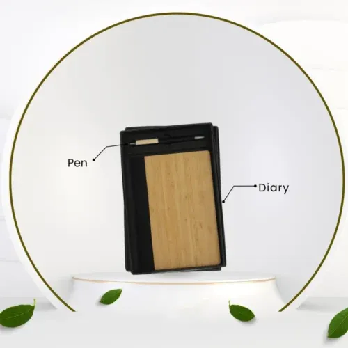 Compact black notebook with a natural bamboo cover panel and a pen, presented as a professional, sustainable item for an Employee Welcome Kit.