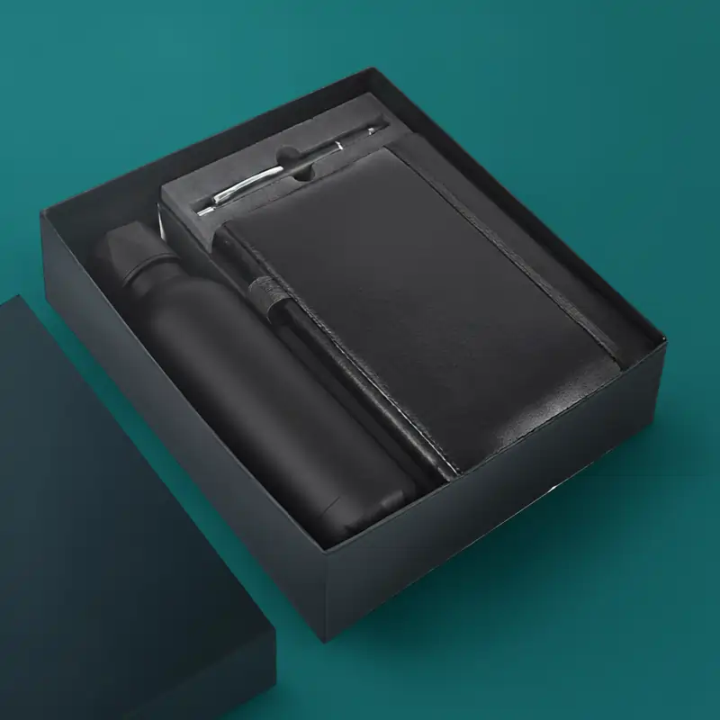 Black Employee Welcome Kit with black water bottle, black notebook, and pen in a black gift box.