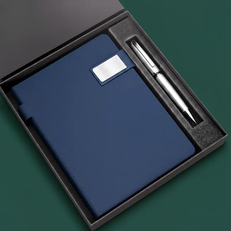 Employee Welcome Kit with a navy blue notebook and a silver pen presented in a sophisticated black gift box.