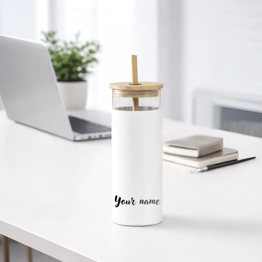glass-sipper-with-straw-01 A white glass tumbler with a bamboo lid and straw on a desk, featuring "Your name" text in black script